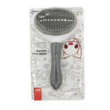 Self-cleaning slicker brush being used on a long-haired dog