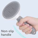 Self-cleaning slicker brush being used on a cat