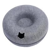 Felt donut cat bed styled in a living room