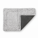 ChillPaw self-heating pet mat on a white background — plush grey sherpa fleece top folded back to show the non-slip dotted underside