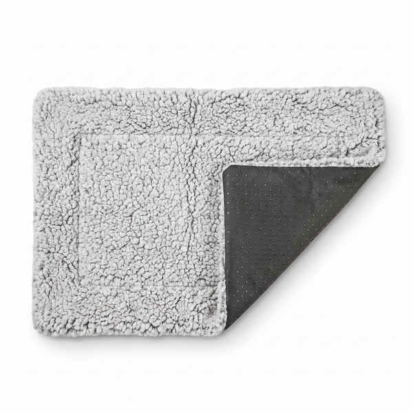 ChillPaw self-heating pet mat on a white background — plush grey sherpa fleece top folded back to show the non-slip dotted underside