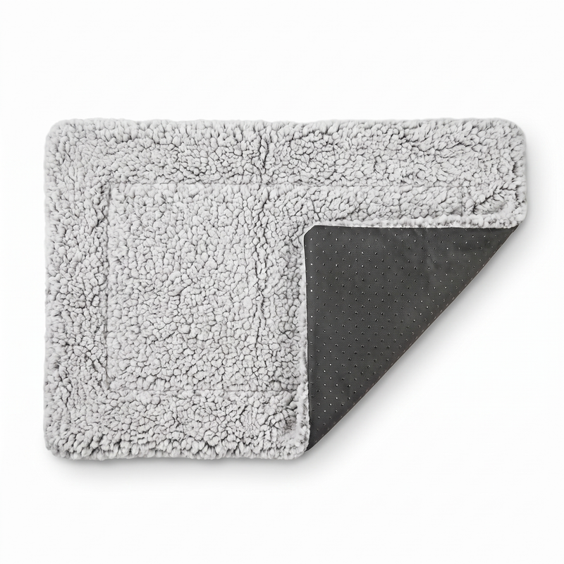 ChillPaw self-heating pet mat on a white background — plush grey sherpa fleece top folded back to show the non-slip dotted underside